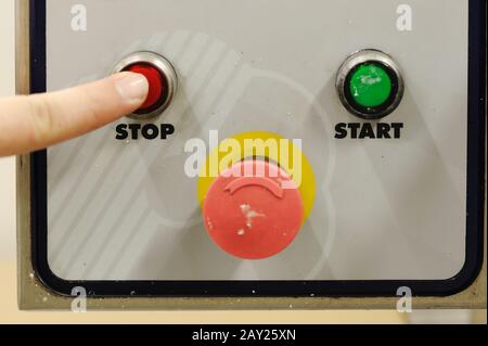 Finger pressing stop button Stock Photo