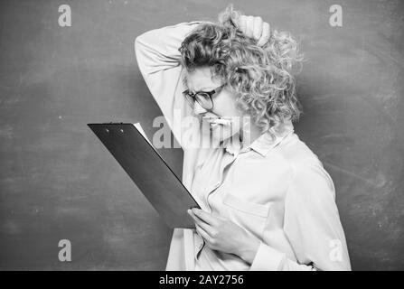 School project. Tutor checking homework. Woman smart lady hold tablet documents. Read personal profile. Estimate essay of applicants. Literature teacher read composition. Read impressing resume. Stock Photo