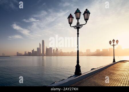 Urban skyline with skyscrapers at beautiful sunrise. Cityscape Abu Dhabi, United Arab Emirates. Stock Photo