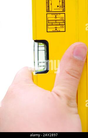 Hand holding yellow level tool Stock Photo