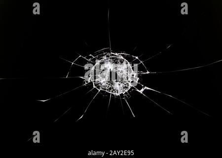 The texture of broken cracked glass after being hit by a solid object. Cracks isolated on white. Concept element for design. Stock Photo