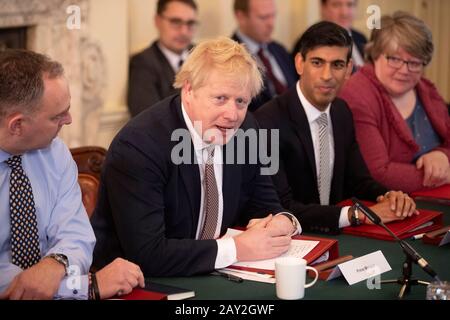 Prime Minister Boris Johnson alongside new Chancellor of the Exchequer Rishi Sunak (second right), Cabinet Secretary Mark Sedwill (left) and Work and Pensions Secretary Therese Coffey (right) during the first Cabinet meeting at 10 Downing Street, London, since the reshuffle. Stock Photo