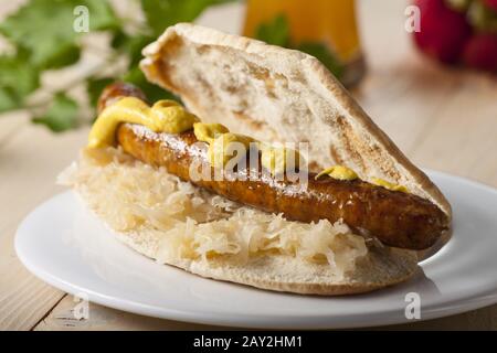 Bavarian sandwich with sauerkraut and fried sausage Stock Photo