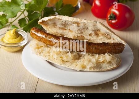 Bavarian sandwich with sauerkraut and fried sausage Stock Photo