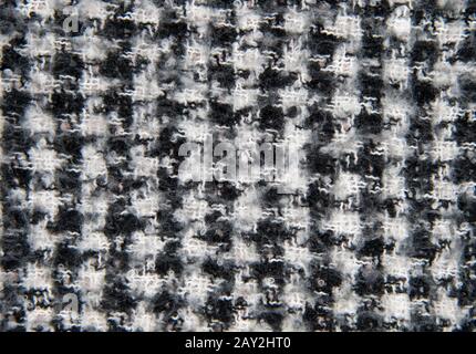 Full frame knitted warm black and white scarf as a backdrop.  Stock Photo