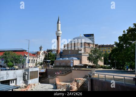 Sofia, Bulgaria - June 16, 2018: Unidentified people, cityscpae with Banya Bashi mosque, Central Market building and entrance to underground station Stock Photo