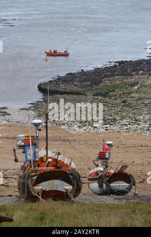 RNLI - B Class lifeboat and boats on dry land - Flamborough Head - East Yorkshire UK Stock Photo