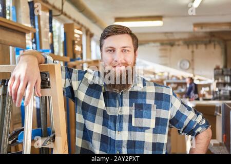 Confident hipster craftsman in a carpentry or joinery Stock Photo