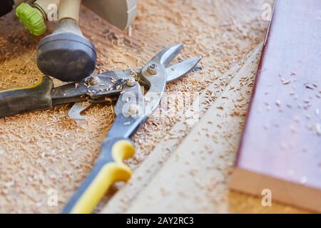 Side cutters and wood shavings between tools in a joinery Stock Photo