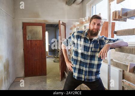 Hipster man with beard as carpenter apprentice in carpentry training Stock Photo