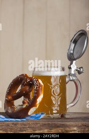 Bavarian beer and a pretzel on wood Stock Photo