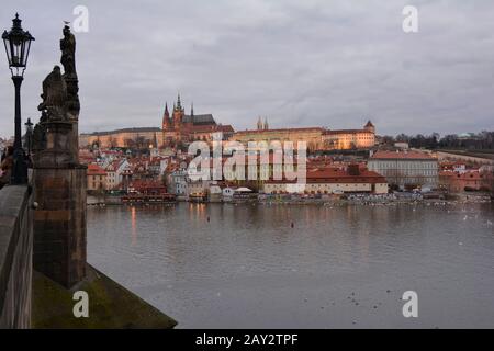 Prague, Czech Republic - December 2nd 2015: View from Charles bridge over river Moldau to castle and St. Vitus cathedral on evening Stock Photo