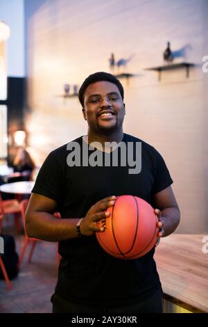 Portrait of smiling basketball player Stock Photo