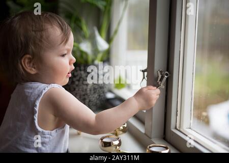 Boy looking out of window Stock Photo