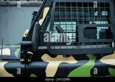 Part of the door of a heavily prepared rough SUV.  Close-up side window with installed protection grille Stock Photo