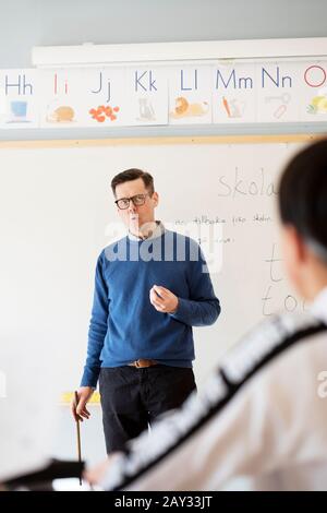 Teacher in classroom Stock Photo
