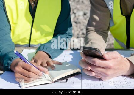 Making notes at construction site Stock Photo