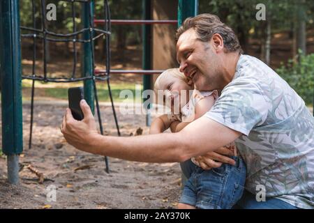 Father and son taking selfie Stock Photo