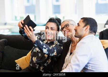 Coworkers taking selfie Stock Photo