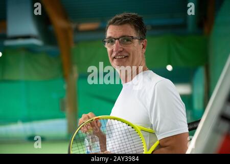Man holding tennis racquet Stock Photo