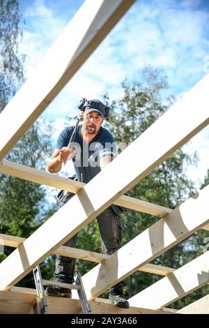 Carpenter working on the roof Stock Photo - Alamy