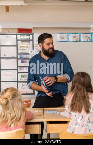 Teacher in classroom Stock Photo