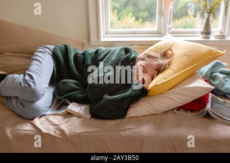 Woman sleeping on sofa Stock Photo