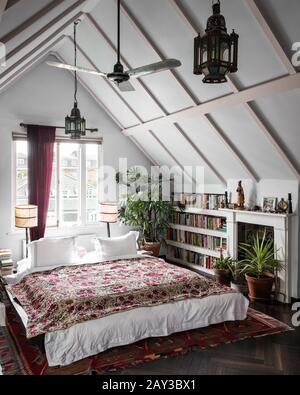 Double bed under gabled ceiling Stock Photo