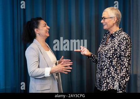 Businesswomen talking together Stock Photo
