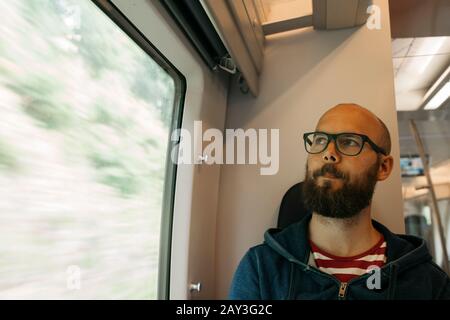 Man sitting in train Stock Photo