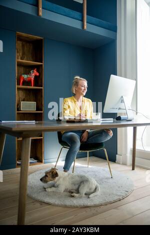 Woman in office using computer Stock Photo