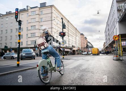 Woman cycling in city Stock Photo