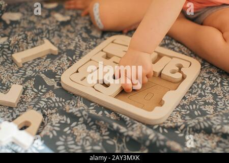 Child solving wooden puzzles Stock Photo