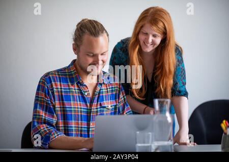 Smiling colleagues looking away Stock Photo