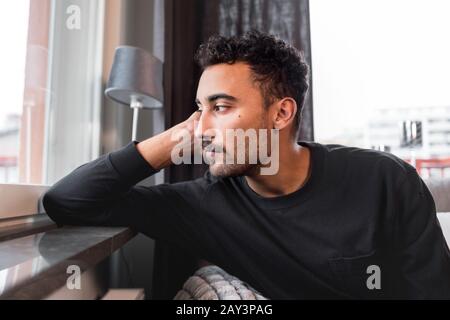 Man looking through window Stock Photo