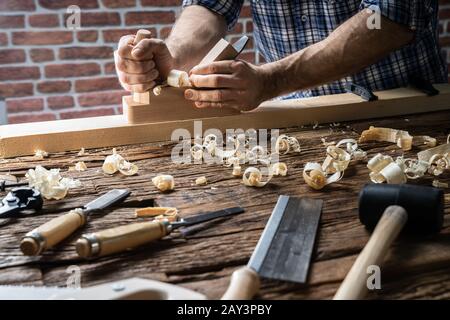 Carpenter Using Jack-plane And Various Tools From Toolkit Stock Photo