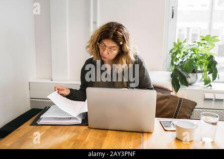Woman looking at documents Stock Photo