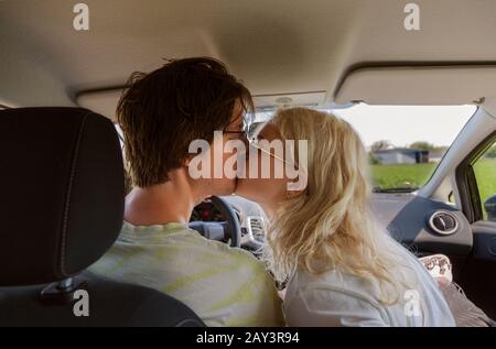 Couple kissing in car Stock Photo