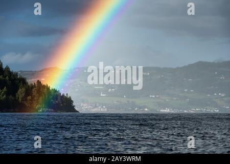 Rainbow over lake Stock Photo