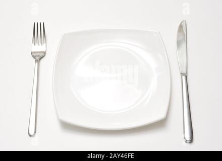 Empty plate with fork and knife Stock Photo