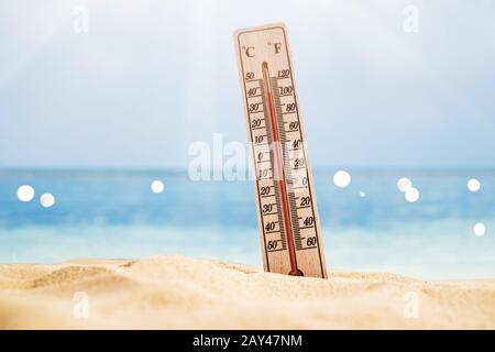 Close-up Of Thermometer On Sand Showing High Temperature Stock Photo