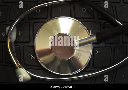 Black stethoscope on the keyboard side Stock Photo