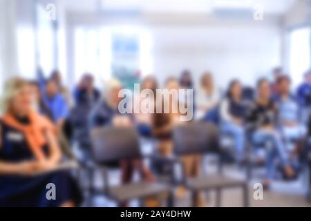 Blurred front view background classroom. High school or undergraduate student sitting on lecture chairs listening to speaker. Education concept Stock Photo