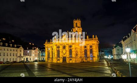 Germany, Famous beautiful cathedral ludwigskirche at ludwig square in downtown saarbrucken city by night with clouds and starry sky Stock Photo
