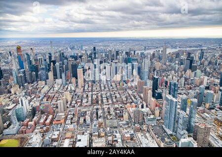 New York City from helicopter point of view. Midtown Manhattan skyscrapers on a cloudy day, USA Stock Photo