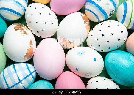 A lot of easter eggs close-up on a green background, place for text, top view, Stock Photo