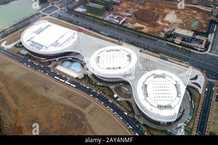 Wuhan. 14th Feb, 2020. Aerial photo taken on Feb. 14, 2020 shows a view of Jiangxia temporary hospital in Wuhan, capital city of central China's Hubei Province. Jiangxia temporary hospital, a 400-bed hospital converted from an outdoor sports center, started to receive COVID-19 patients with mild symptoms on Friday. The hospital is the first temporary hospital that mainly adopt Traditional Chinese medicines (TCM) to treat the patients. Credit: Cheng Min/Xinhua/Alamy Live News Stock Photo