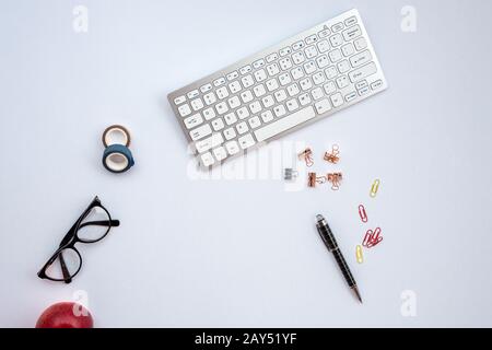 White desk with a stationery and other objects on it Stock Photo