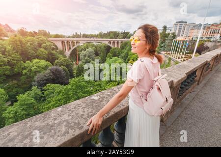 Happy Asian girl stands on the balcony of the observation deck in the Grand Duchy of Luxembourg. Tourism and travel in Europe Stock Photo