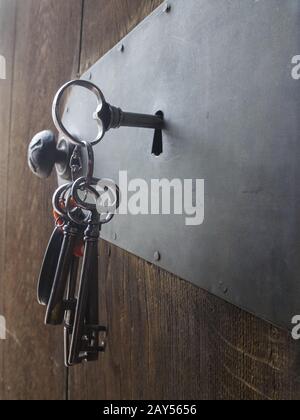 old keys in a door lock Stock Photo